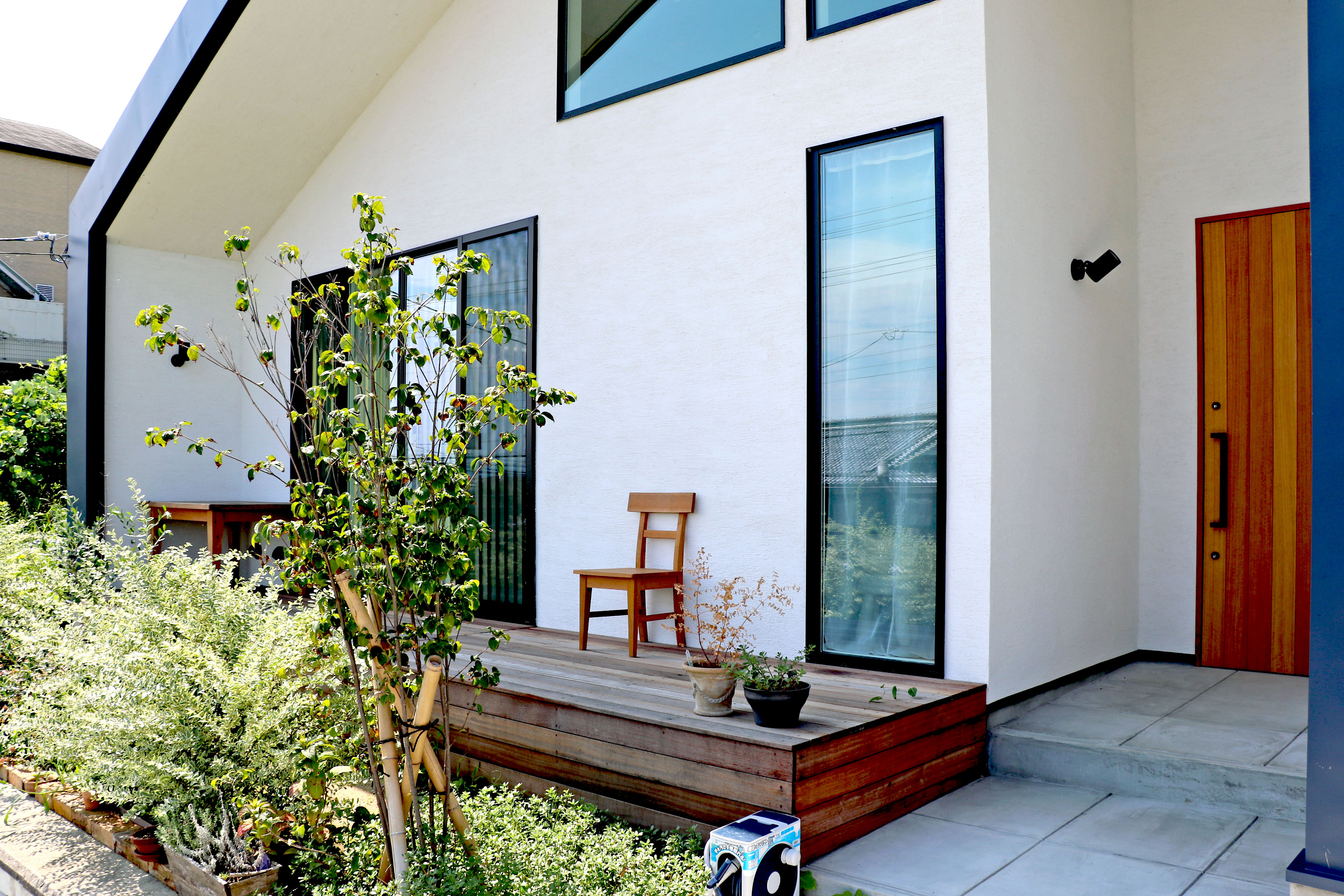 蒼ガルバリウムと白モルタル塗り壁のコントラストが美しい家